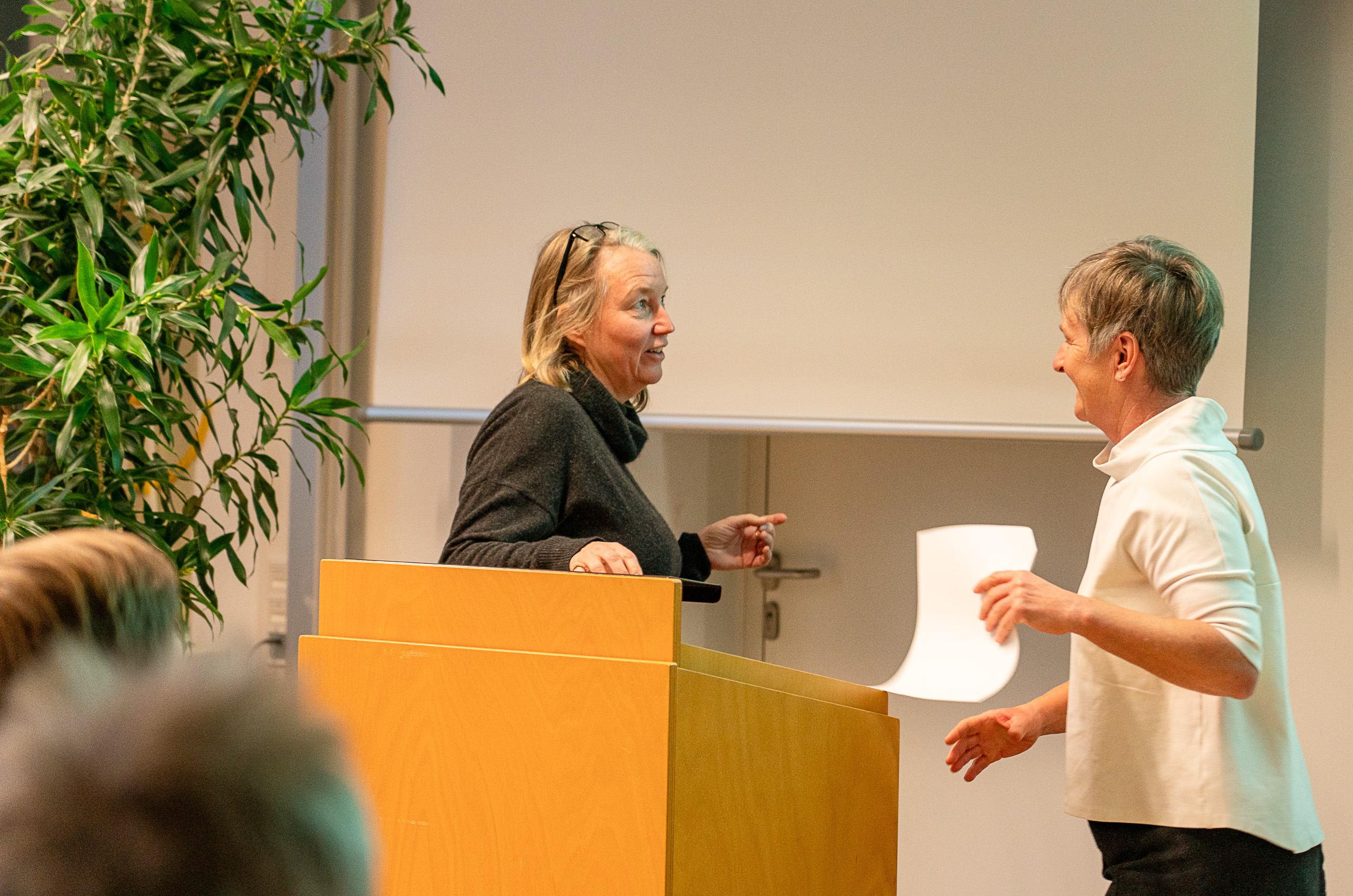 Zwei Frauen stehen an einem Rednerpult