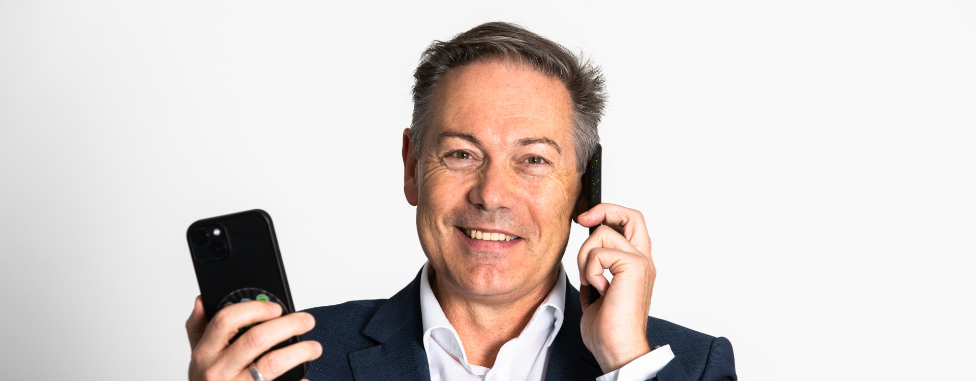 Porträt Mann mit zwei Handys in der Hand