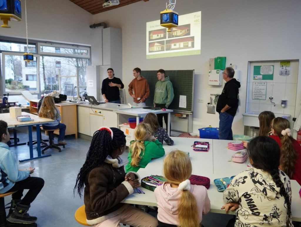 Kinder sitzen in der Schule und planen ein Gebäude