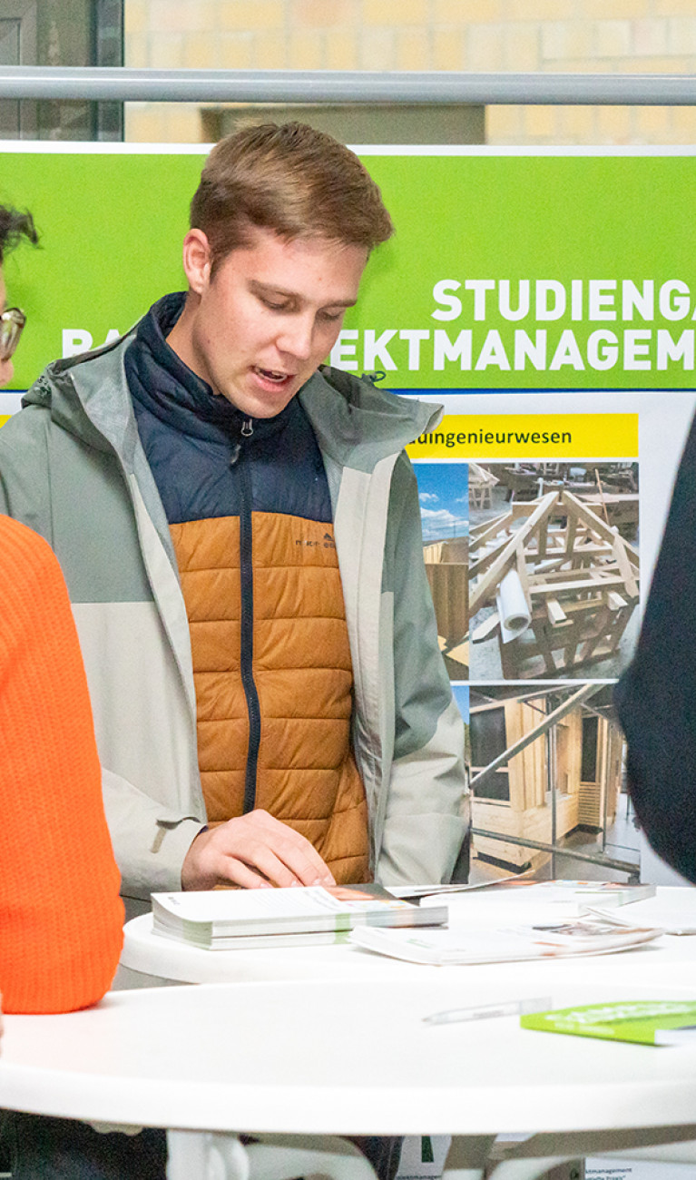 Interessierte stehen an einem Messestand