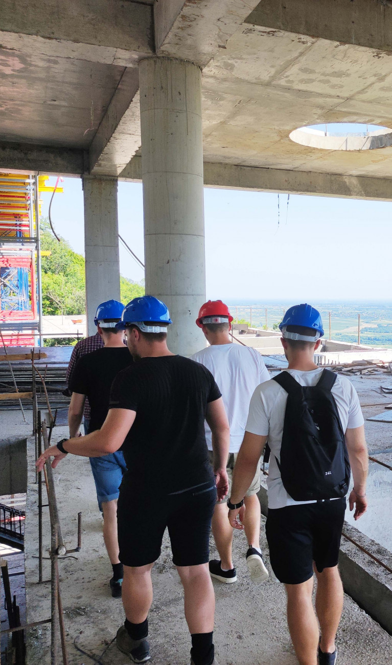 Menschen auf einer Baustelle mit Bauhelmen 