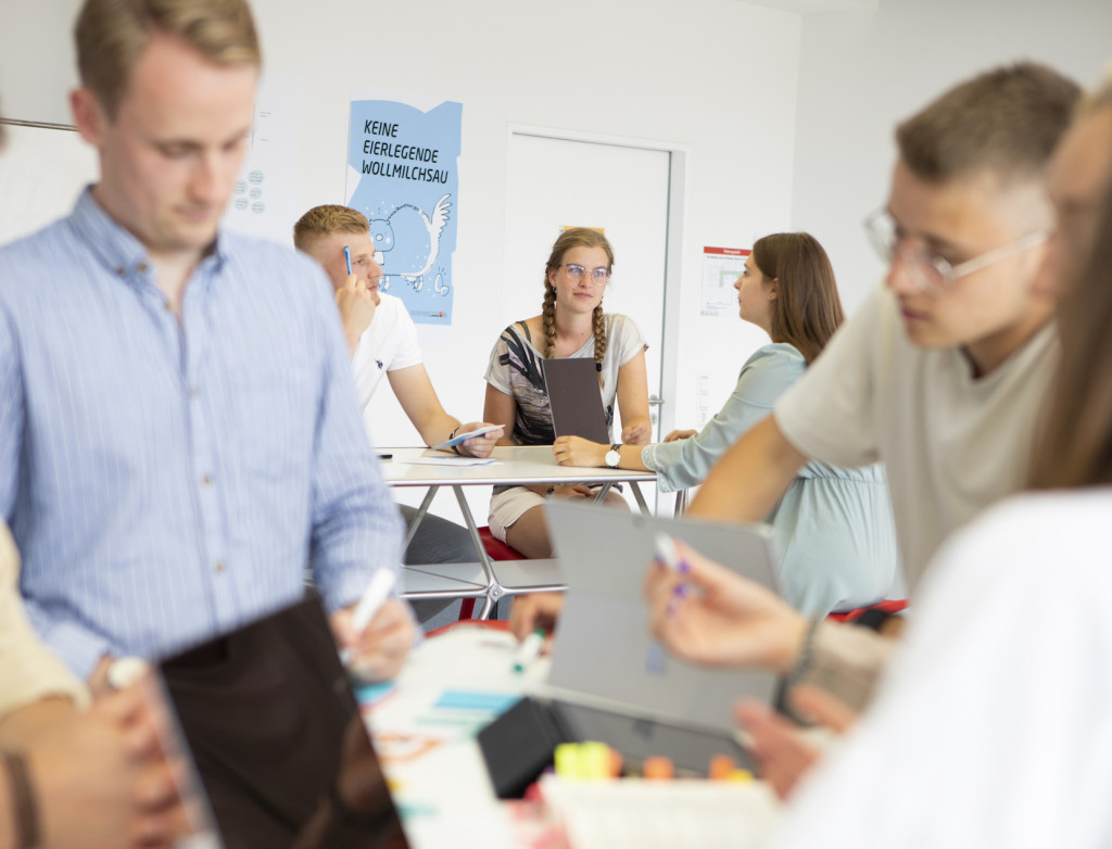 Studierende bei Gruppenarbeit an einem Tisch
