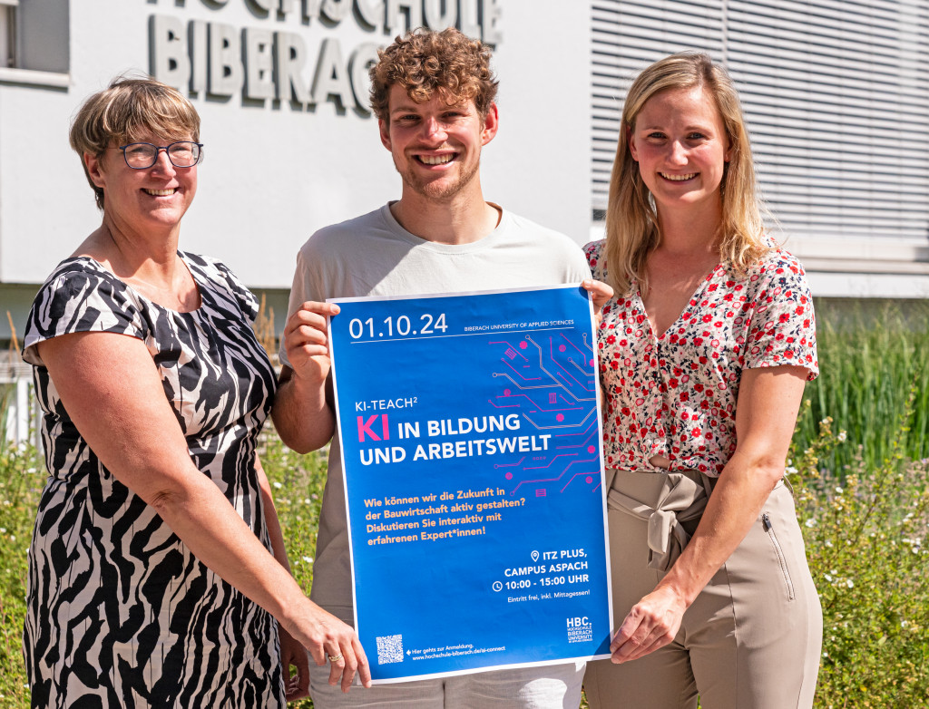 Drei Personen zeigen ein Plakat in die Kamera